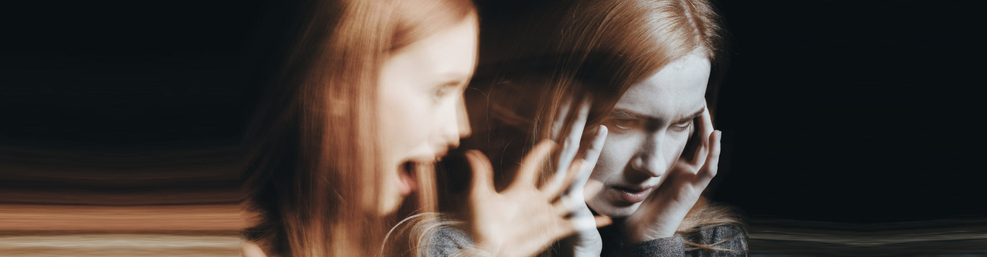 Girl with schizophrenia covering her ears to not hear the voice of her alter ego.