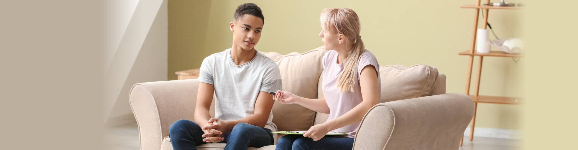 Female psychologist and a teenage boy talking