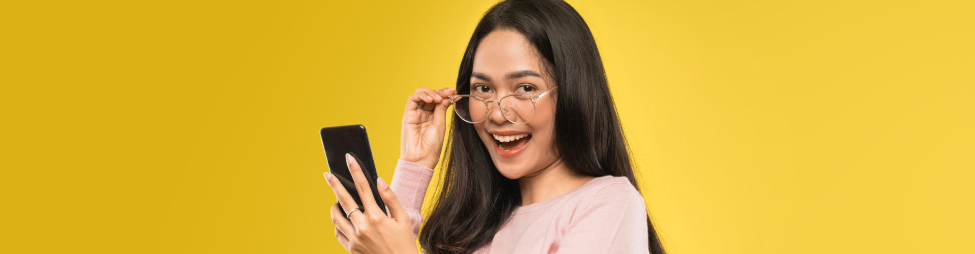 beautiful woman laughing looking at the screen of a smartphone