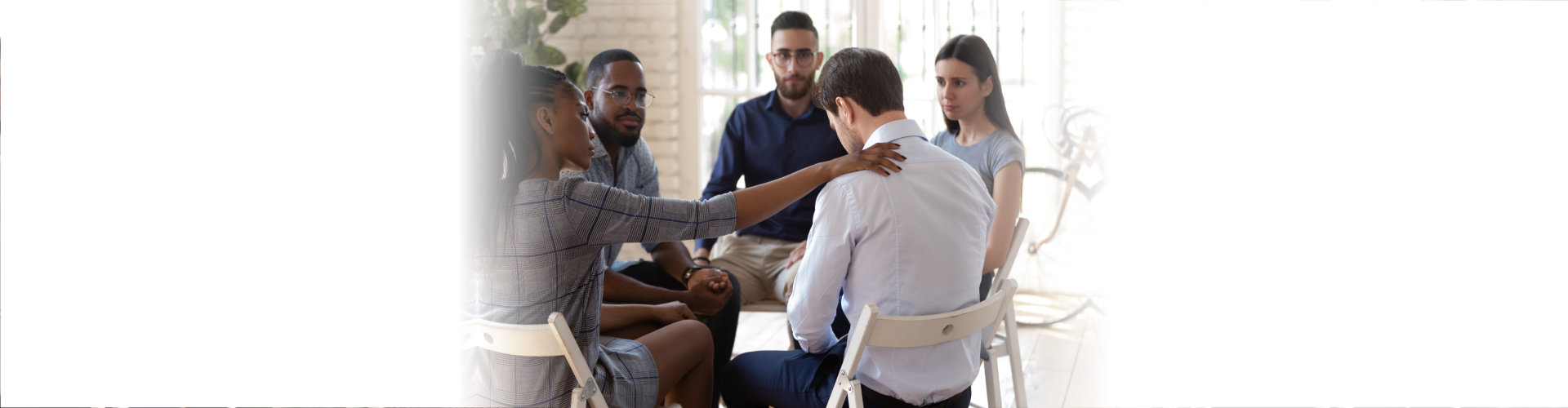 african american female employee putting hand on coworkers shoulder